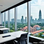 Home 19 물리적 공간의 디지털화에 필요한 기술 - A modern Malaysian office environment showcasing smart technology integration: employees working com...